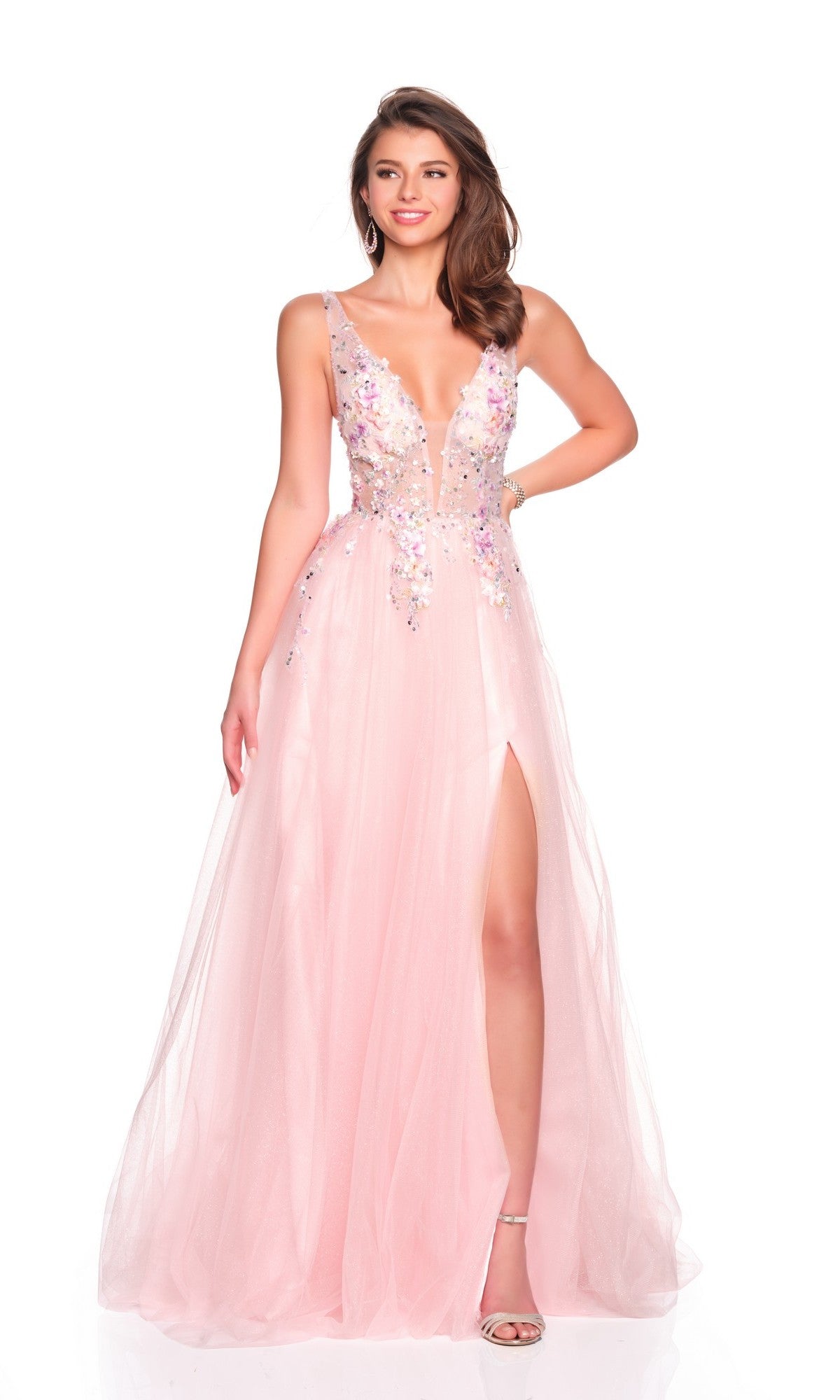 A woman stands against a white background wearing the Dave and Johnny 12591 long prom dress—sleeveless, floor-length, light pink with a plunging neckline, sequin details, a thigh-high slit, and an elegant A-line tulle skirt.